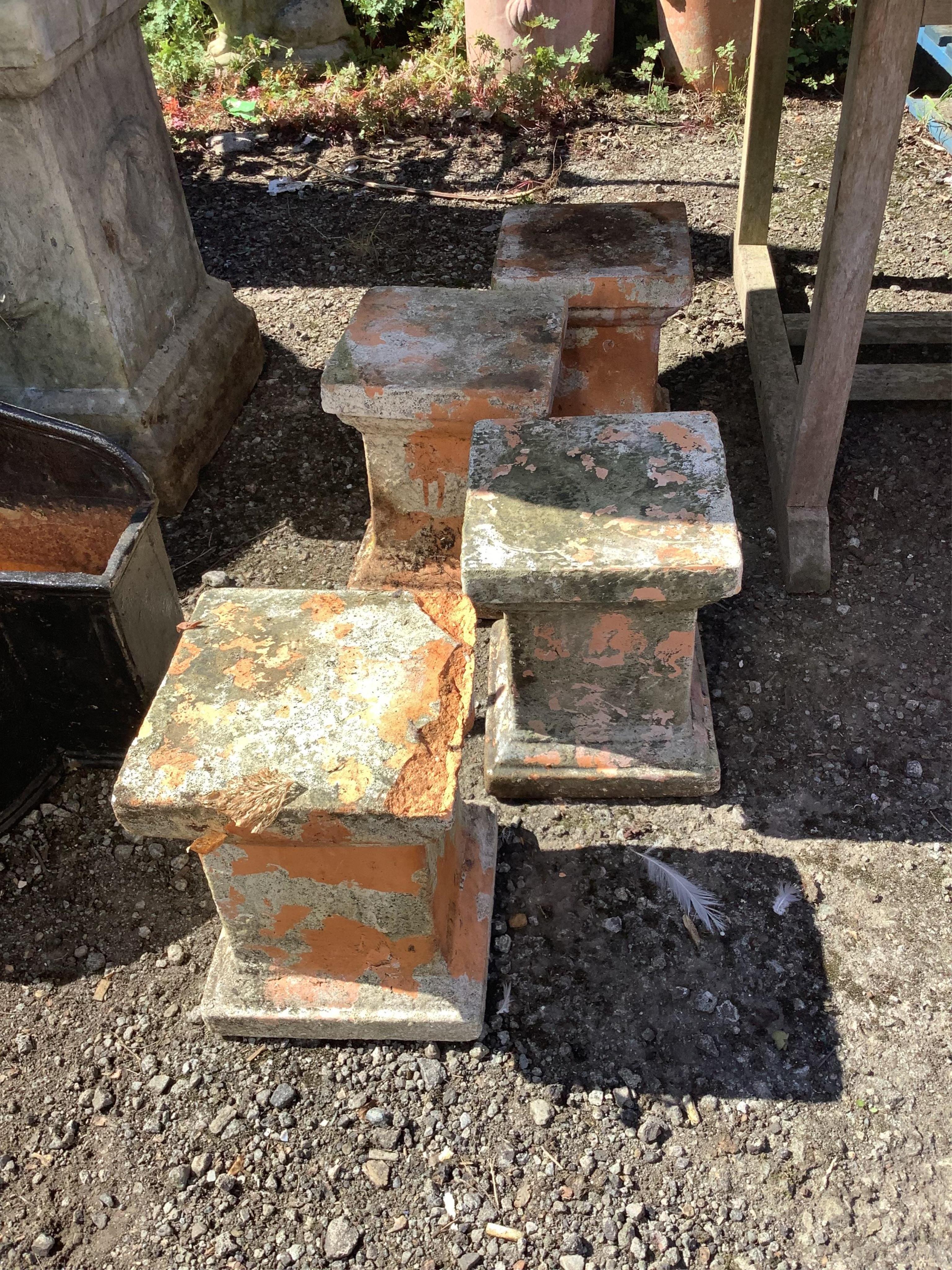 A set of four square terracotta garden plinths, height 29cm. Condition - fair